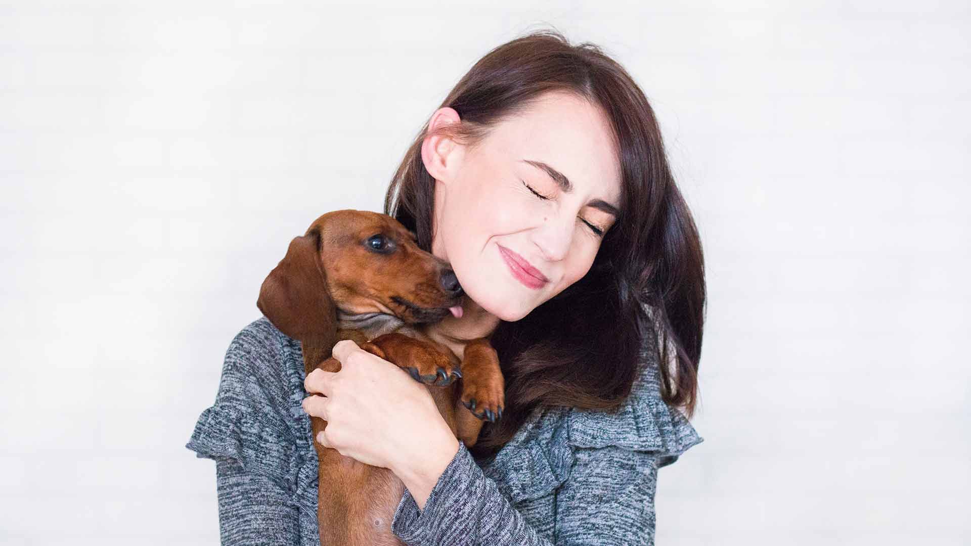 dog-kissing-brunette-woman