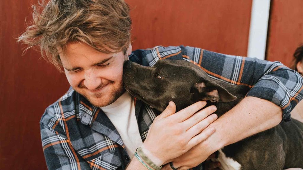 dog-kissing-a-guy
